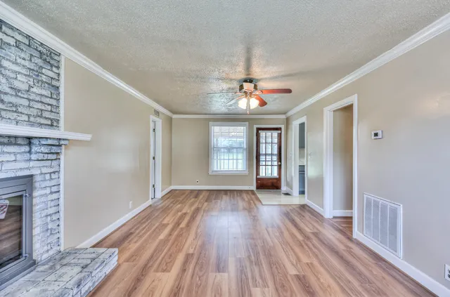a view of livingroom with hardwood floor and kitchen view