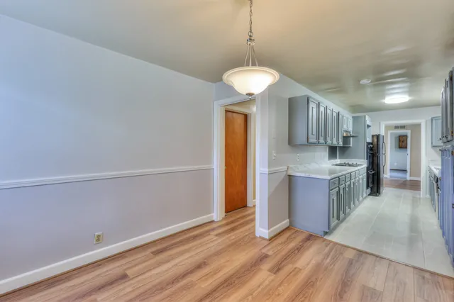 a view of a kitchen with a sink and a refrigerator