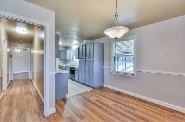 a view of a room with wooden floor and windows
