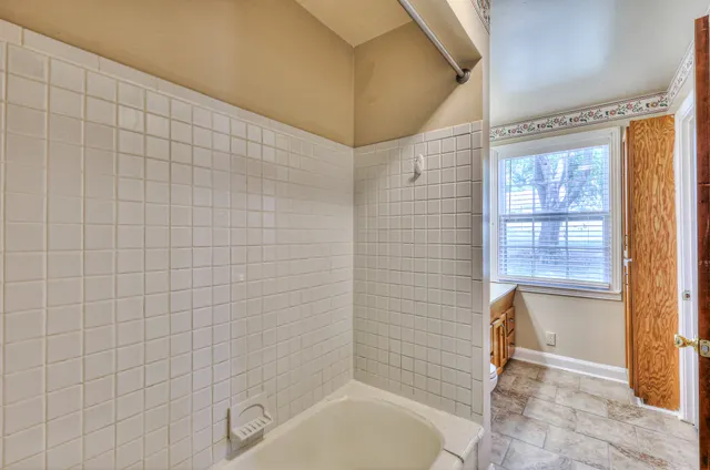 a bathroom with a bathtub and shower