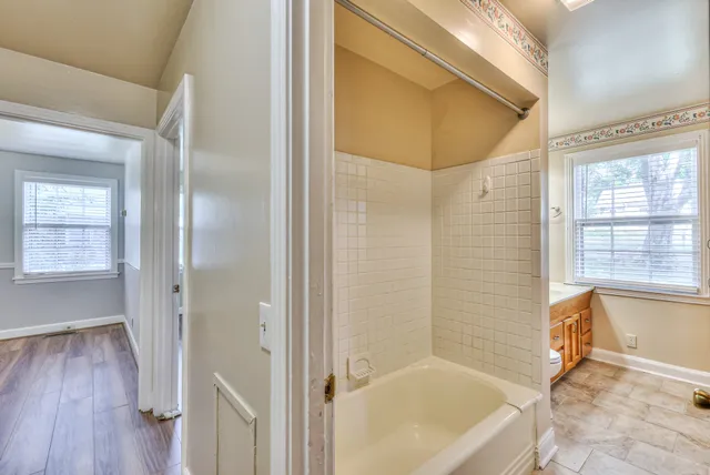 a bathroom with a tub and shower