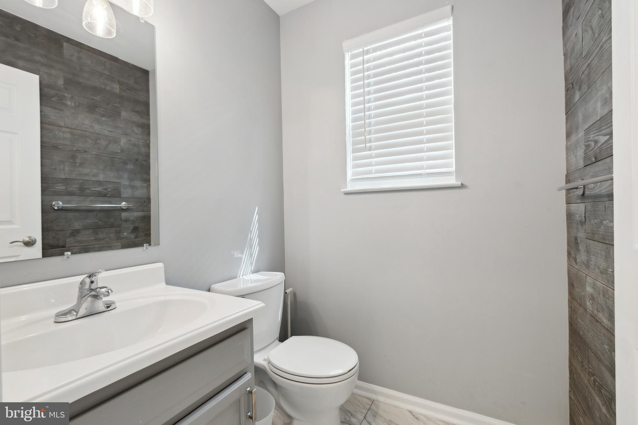 45 Country Club Road Pine Hill, NJ 08021 - Photo 11 of 25 a bathroom with a sink a toilet and a window