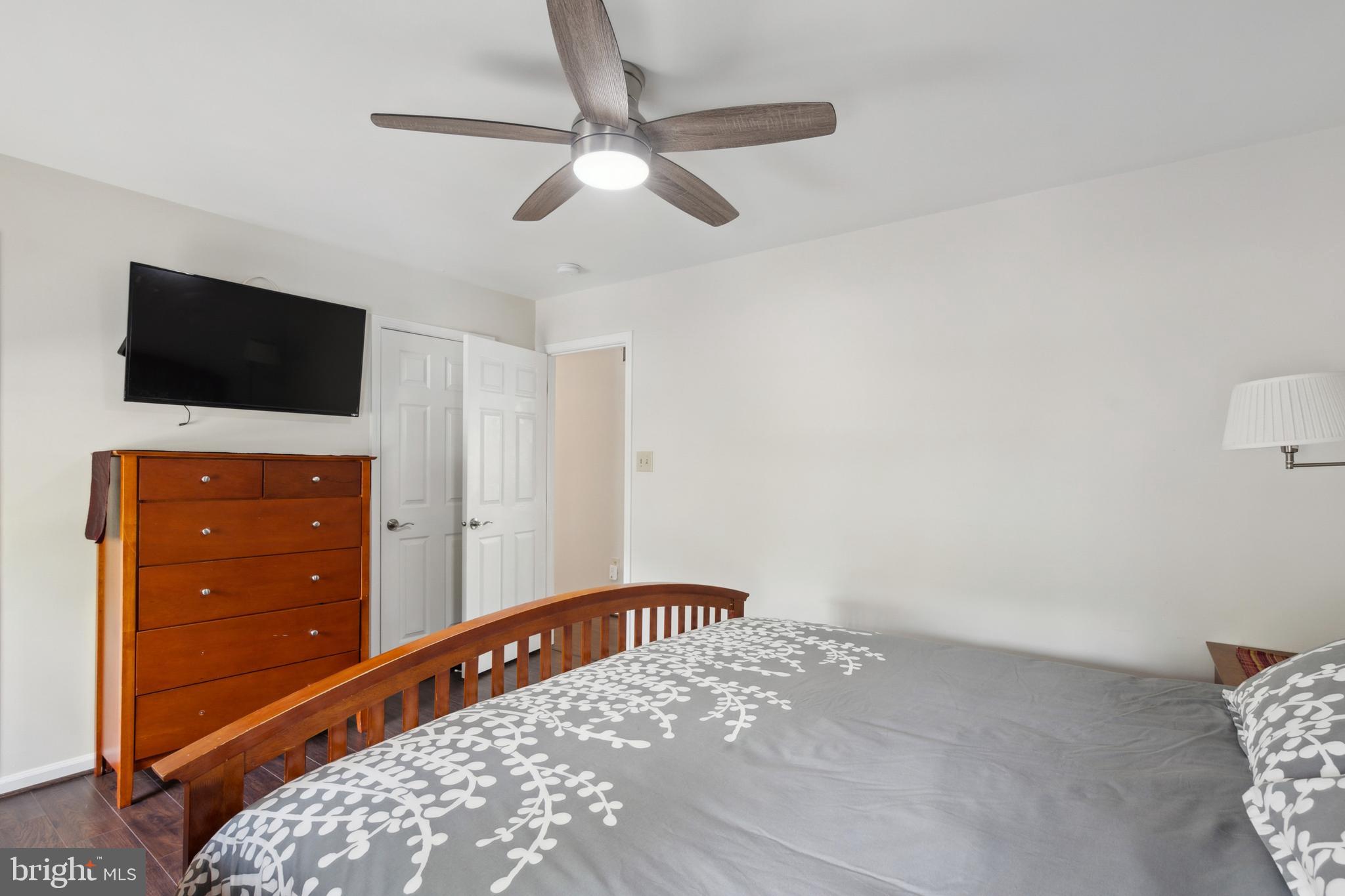 45 Country Club Road Pine Hill, NJ 08021 - Photo 20 of 25 a view of a bedroom with a flat tv screen and a ceiling fan