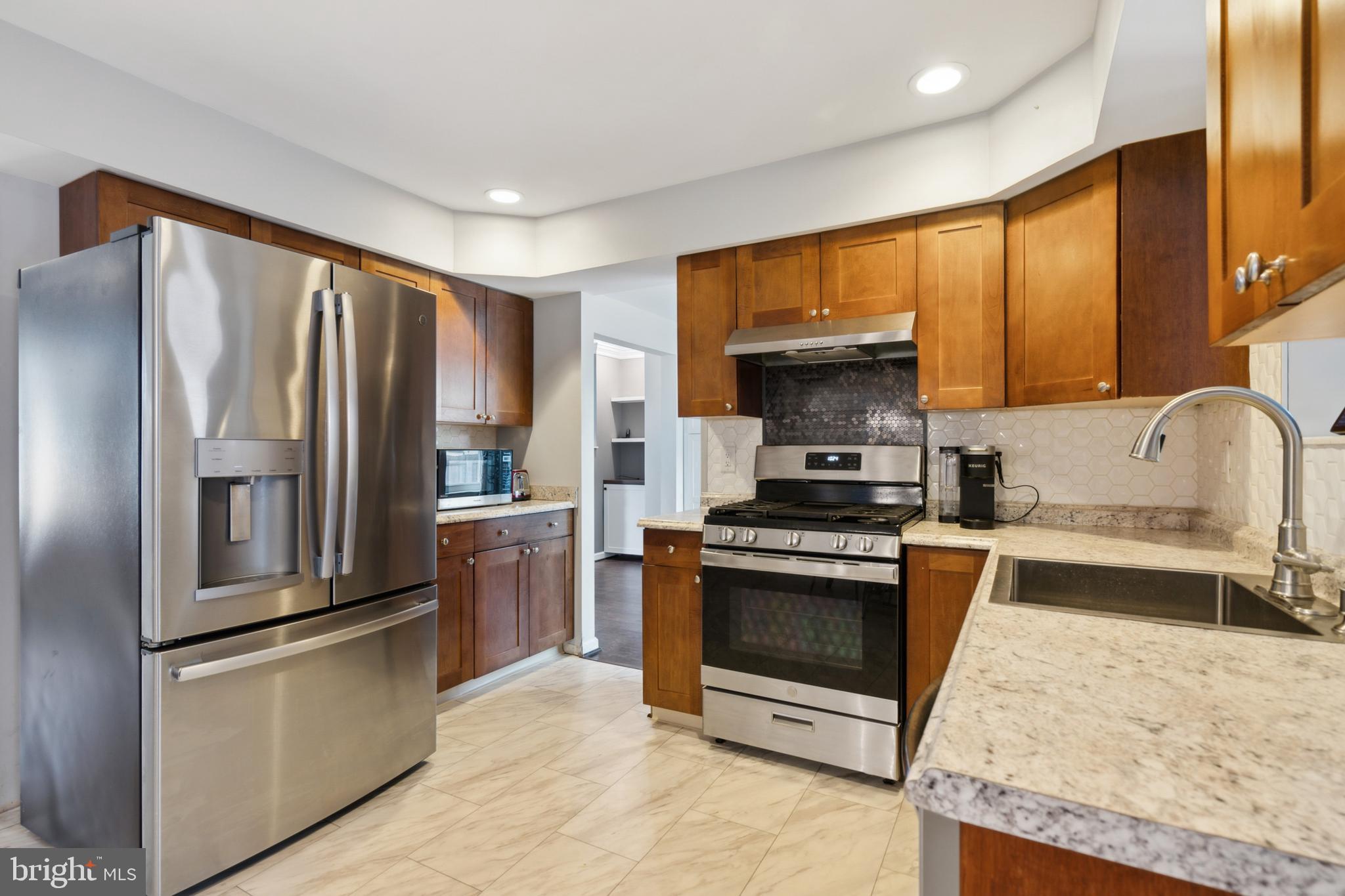 45 Country Club Road Pine Hill, NJ 08021 - Photo 6 of 25 a kitchen with granite countertop a refrigerator stove and sink