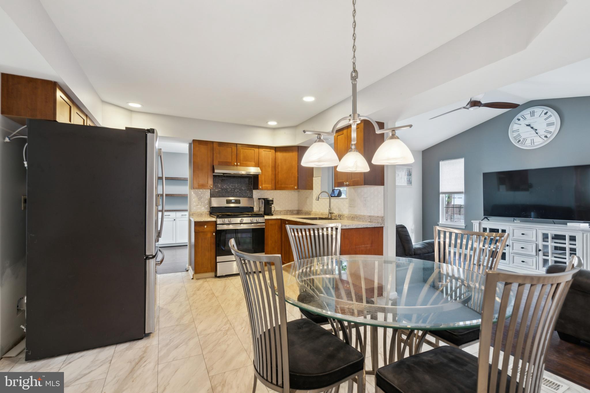 45 Country Club Road Pine Hill, NJ 08021 - Photo 8 of 25 a kitchen with stainless steel appliances granite countertop a refrigerator a stove a kitchen island a dining table and chairs