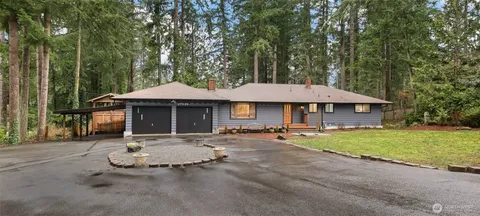 a front view of a house with garden and patio