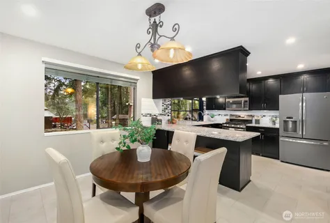 a kitchen with a dining table and chairs