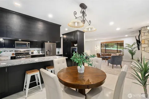 a kitchen with a dining table and chairs