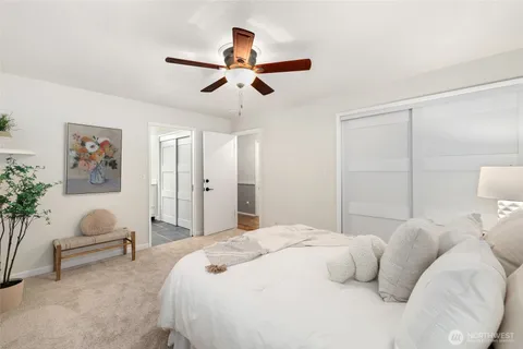 a bedroom with a large bed and a chandelier
