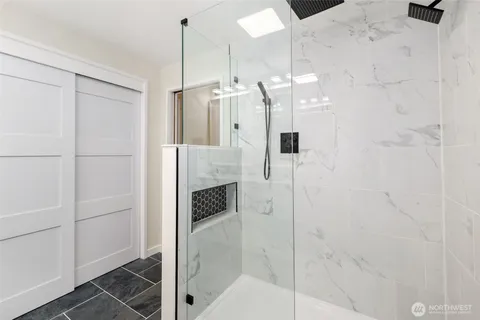 a bathroom with a shower and closet