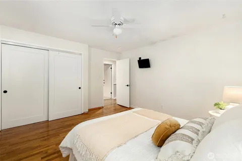 a bedroom with a bed and a ceiling fan