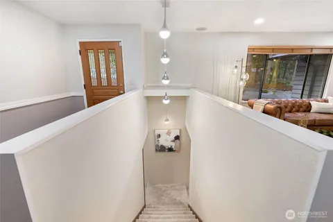 a view of a hallway with windows and stairs