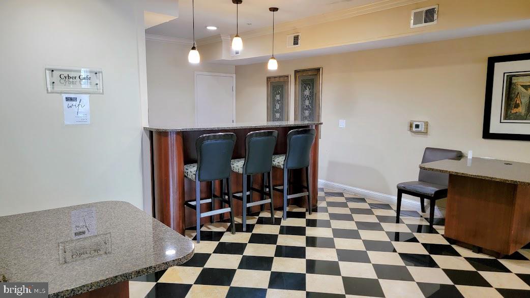 501 Hungerford Drive, Unit 207 Rockville, MD 20850 - Photo 17 of 23 a living room with a black white checkered floor with couches chair and a coffee table