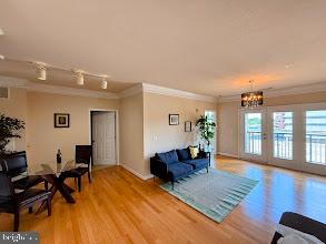 501 Hungerford Drive, Unit 207 Rockville, MD 20850 - Photo 3 of 23 a living room with furniture and a wooden floor