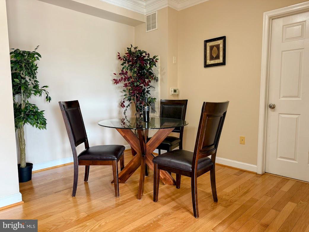 501 Hungerford Drive, Unit 207 Rockville, MD 20850 - Photo 4 of 23 a view of a dining room with furniture and wooden floor