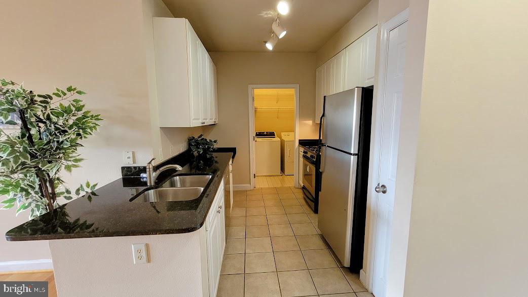 501 Hungerford Drive, Unit 207 Rockville, MD 20850 - Photo 5 of 23 a kitchen with a sink and refrigerator
