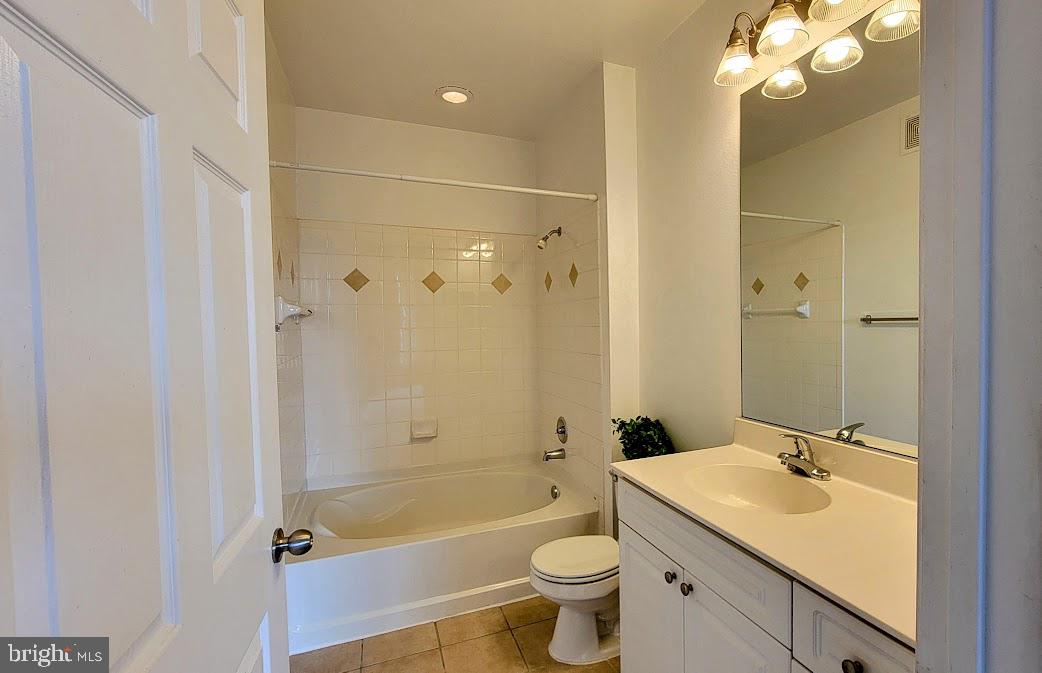 501 Hungerford Drive, Unit 207 Rockville, MD 20850 - Photo 9 of 23 a bathroom with a sink a toilet and shower