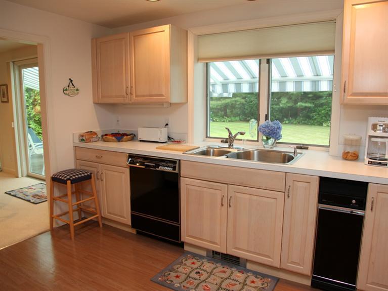 105 Scudder Road Osterville, MA 02655 - Photo 4 of 10 a kitchen with a sink stove and cabinets