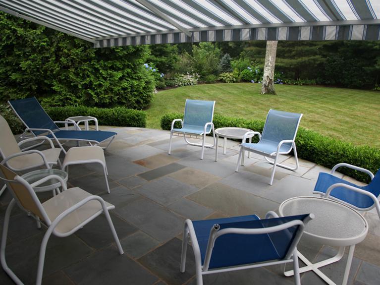 105 Scudder Road Osterville, MA 02655 - Photo 5 of 10 a view of a chairs and table in patio with a yard