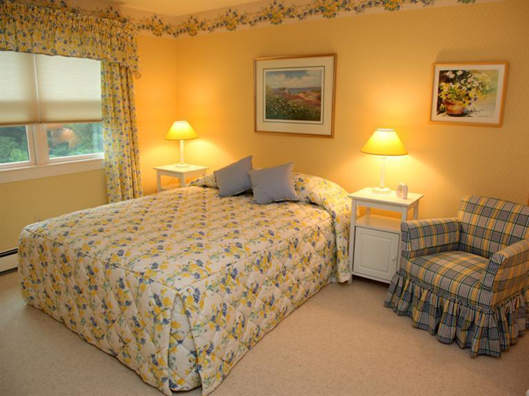 105 Scudder Road Osterville, MA 02655 - Photo 8 of 10 a bedroom with a bed and lamp with window