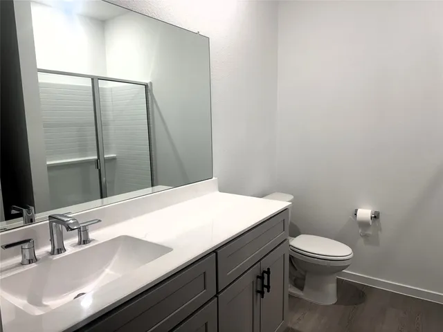 a bathroom with a sink a toilet and mirror