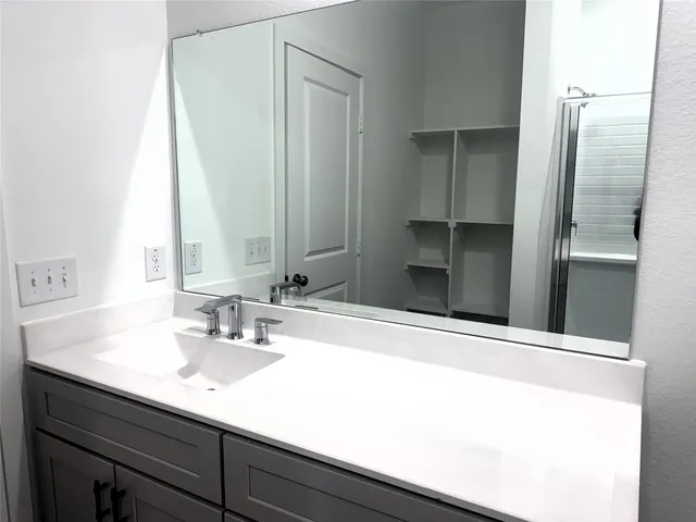 a bathroom with a sink and a mirror