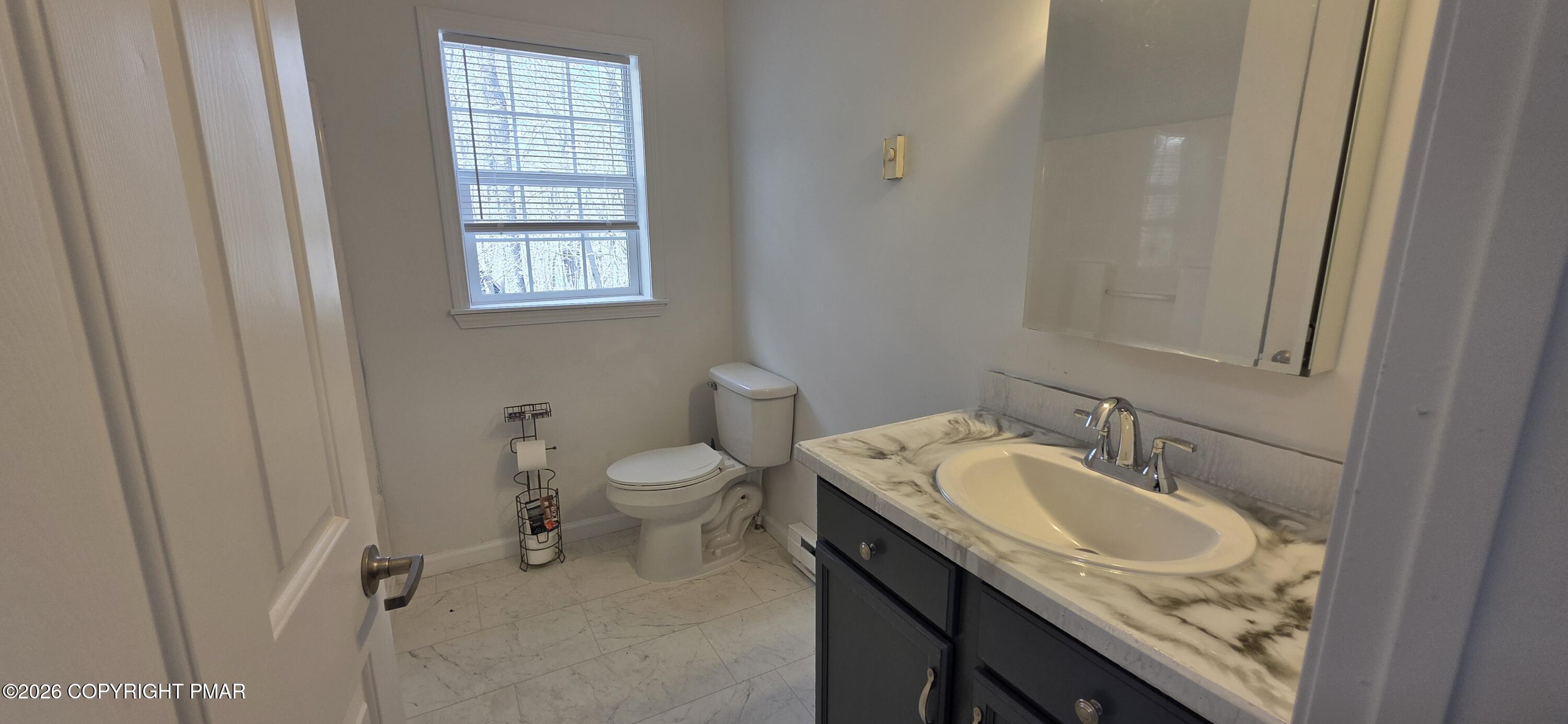 4715 Norwood Lane Tobyhanna, PA 18466 - Photo 10 of 14 a bathroom with a granite countertop sink toilet and mirror