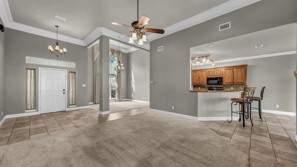 1106 Owl Street Decatur, TX 76234 - Photo 16 of 40 a view of a livingroom with a chandelier furniture and windows