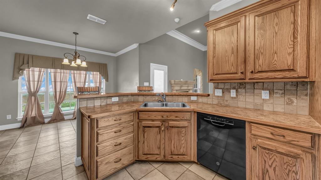 1106 Owl Street Decatur, TX 76234 - Photo 20 of 40 a kitchen with a sink stove and cabinets