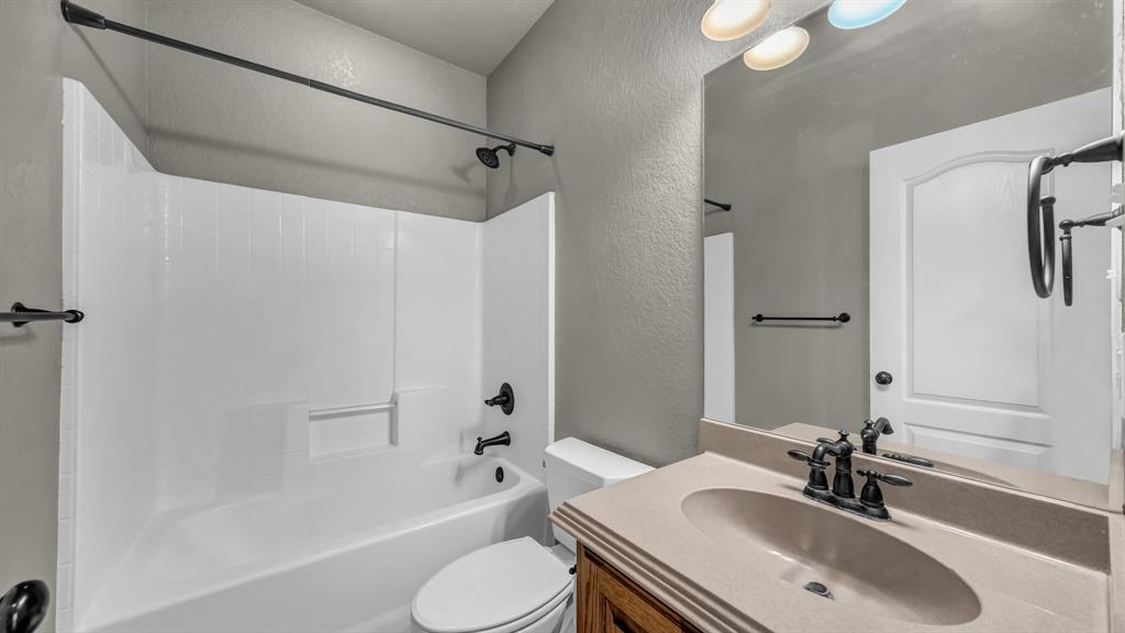 1106 Owl Street Decatur, TX 76234 - Photo 32 of 40 a bathroom with a sink toilet tub and shower