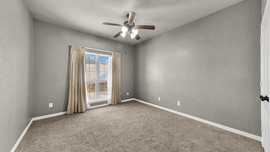 1106 Owl Street Decatur, TX 76234 - Photo 33 of 40 an empty room with chandelier fan