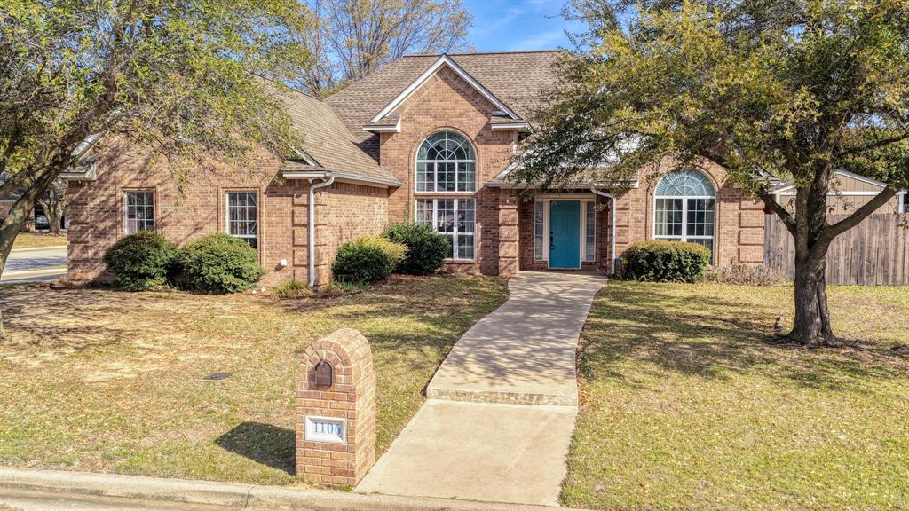 1106 Owl Street Decatur, TX 76234 - Photo 5 of 40 a front view of a house with a yard and garage