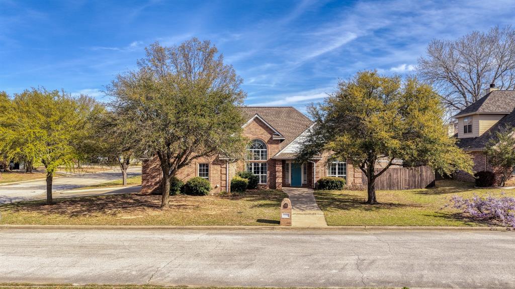 1106 Owl Street Decatur, TX 76234 - Photo 6 of 40 a view of a white house with a road next to a building