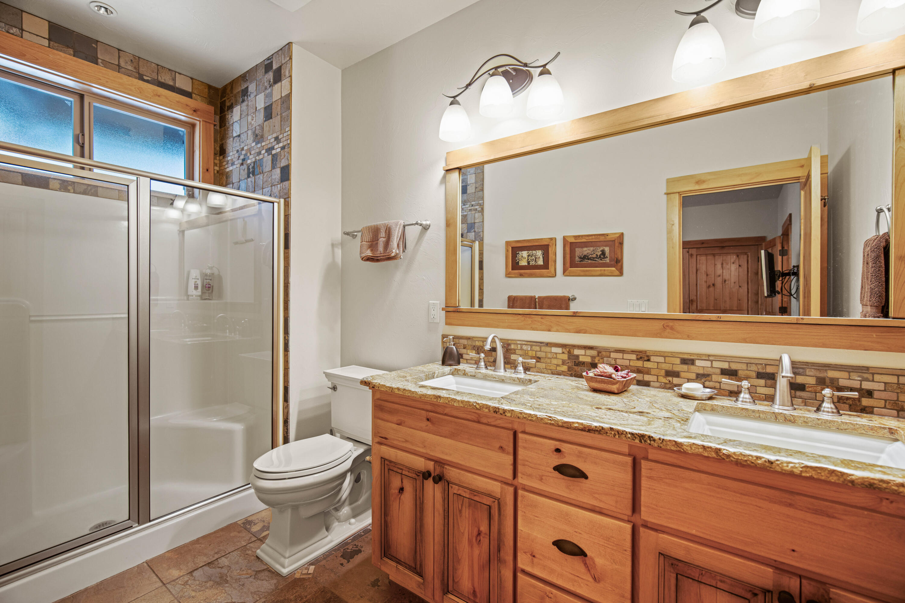 56689 Dancing Rock Loop Bend, OR 97707 - Photo 29 of 51 a bathroom with a sink toilet and shower