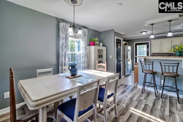 209 Eagle Pointe Drive Chapin, SC 29036 - Photo 9 of 40 a view of a dining room with furniture window and wooden floor