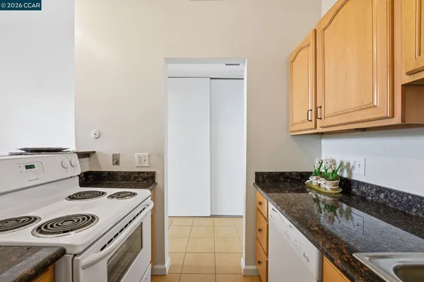 a outdoor space with the couches and dining table with the view of potted plants