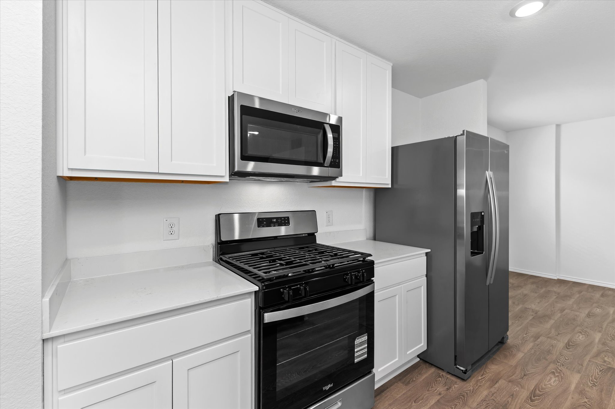 456 Sandringham Loop Kyle, TX 78640 - Photo 37 of 40 A clean, functional kitchen featuring white cabinetry and stainless steel appliances.
