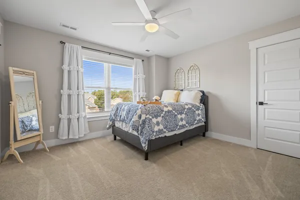 a bed sitting in a room next to a window
