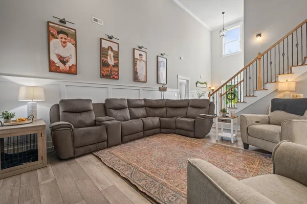 a living room with furniture and stairs
