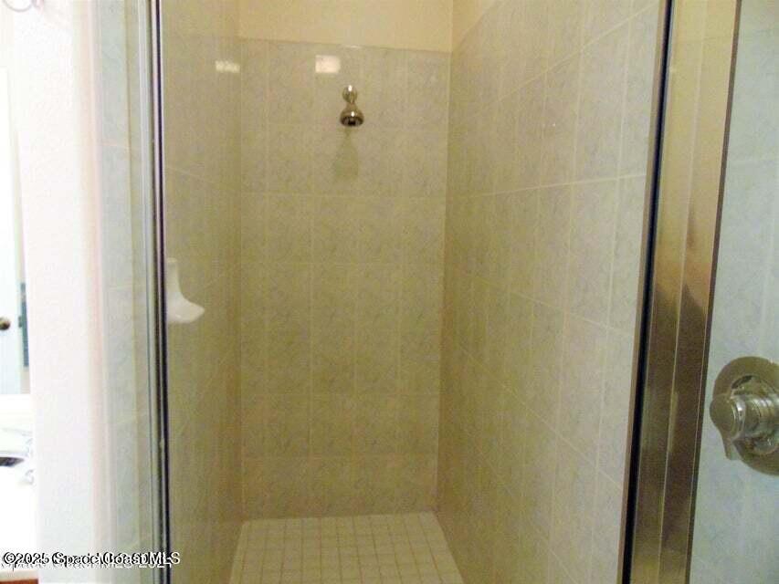 2087 Hidden Grove Lane, Unit 105B Merritt Island, FL 32953 - Photo 17 of 22 a bathroom with a shower