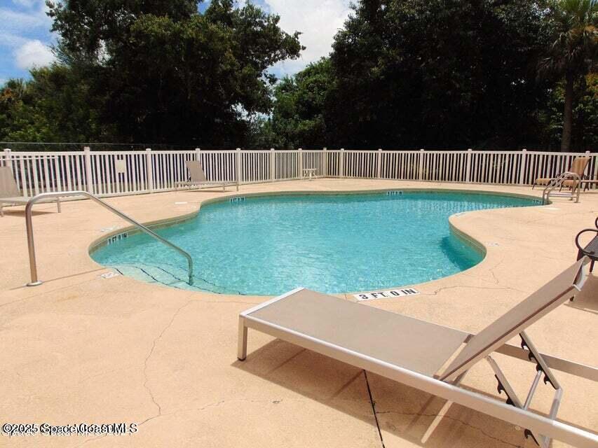 2087 Hidden Grove Lane, Unit 105B Merritt Island, FL 32953 - Photo 3 of 22 a view of swimming pool with a patio