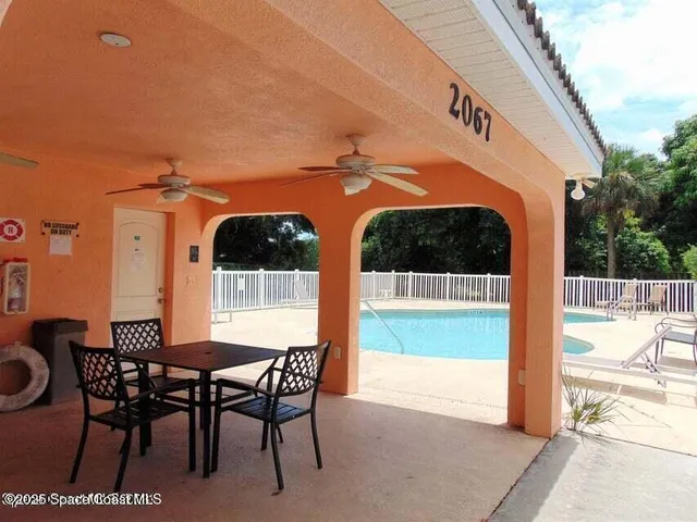 a view of a patio with a table and chairs