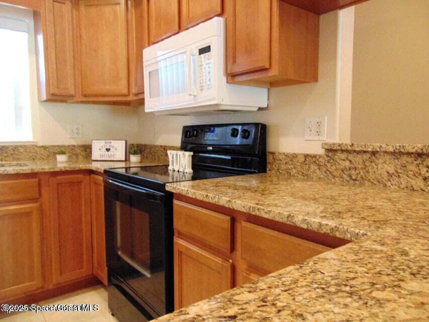 2087 Hidden Grove Lane, Unit 105B Merritt Island, FL 32953 - Photo 5 of 22 a kitchen with stainless steel appliances granite countertop a sink stove and cabinets