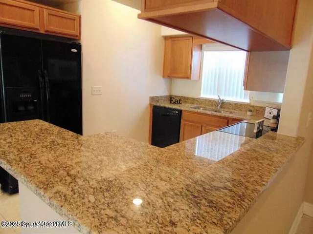 a kitchen with a stove and a refrigerator