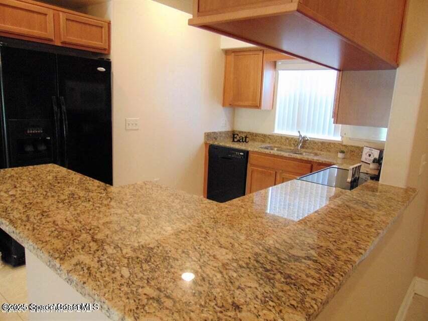 2087 Hidden Grove Lane, Unit 105B Merritt Island, FL 32953 - Photo 6 of 22 a kitchen with a stove and a refrigerator