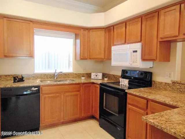 a kitchen with a sink stove top oven and cabinets