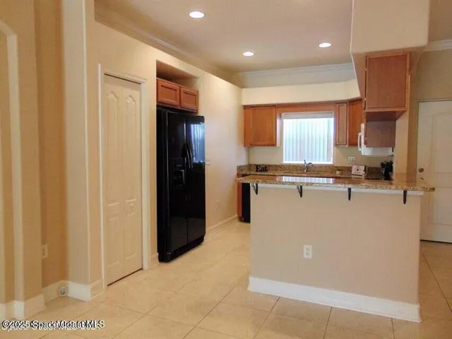 a view of a kitchen with stainless steel appliances granite countertop cabinets and a refrigerator