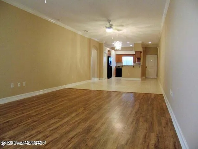 a view of a kitchen with a sink and wooden floor