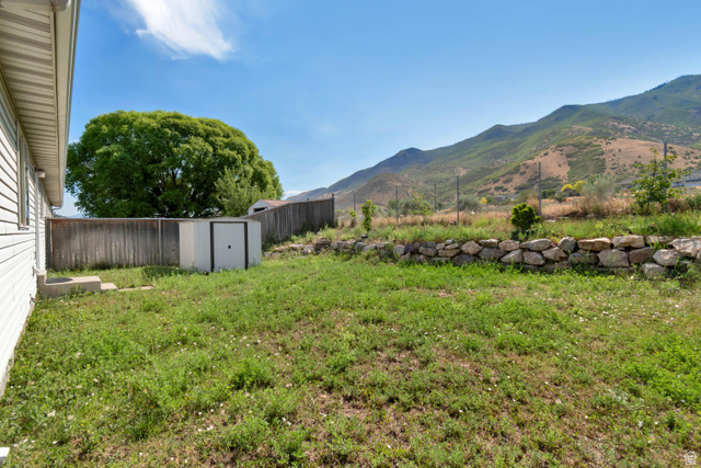 254 North 700 East Santaquin, UT 84655 - Photo 13 of 15 Expansive backyard featuring a natural stone retaining wall and mountain backdrop
