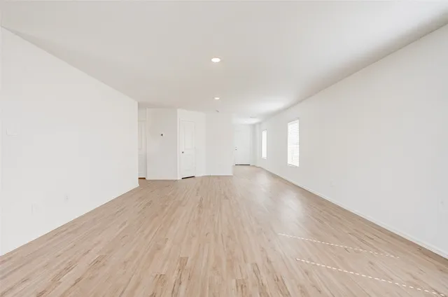 a view of an empty room and wooden floor